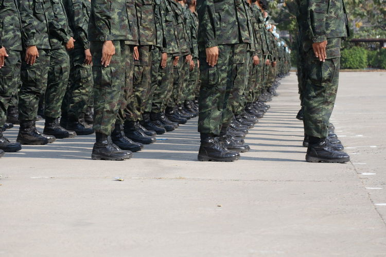 Low section of soldiers walking on street