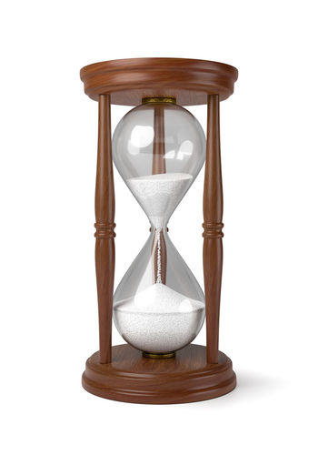 Close-up of clock on table against white background