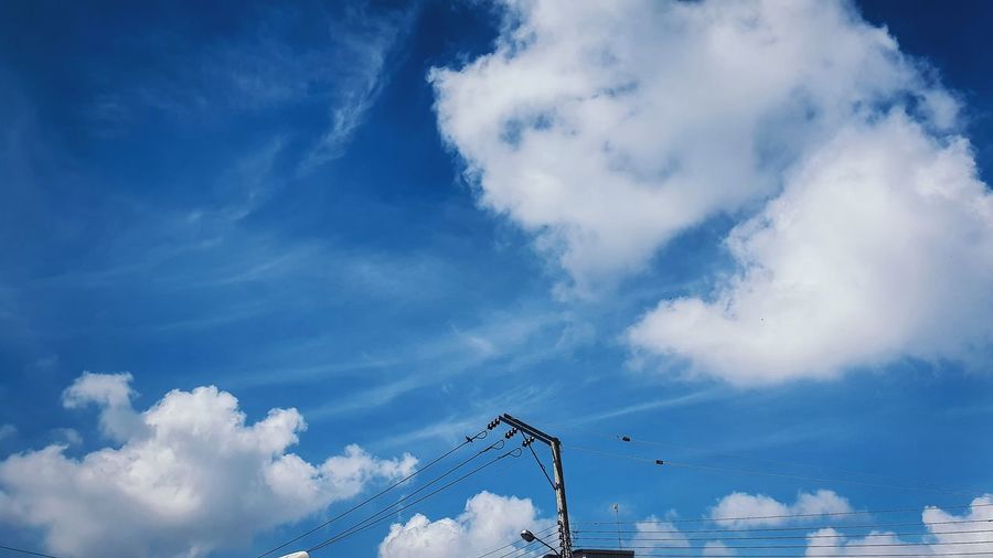Low angle view of crane against blue sky