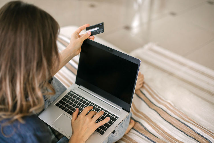 Woman doing online shopping through credit card