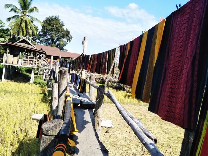 Row of clothes hanging on clothesline
