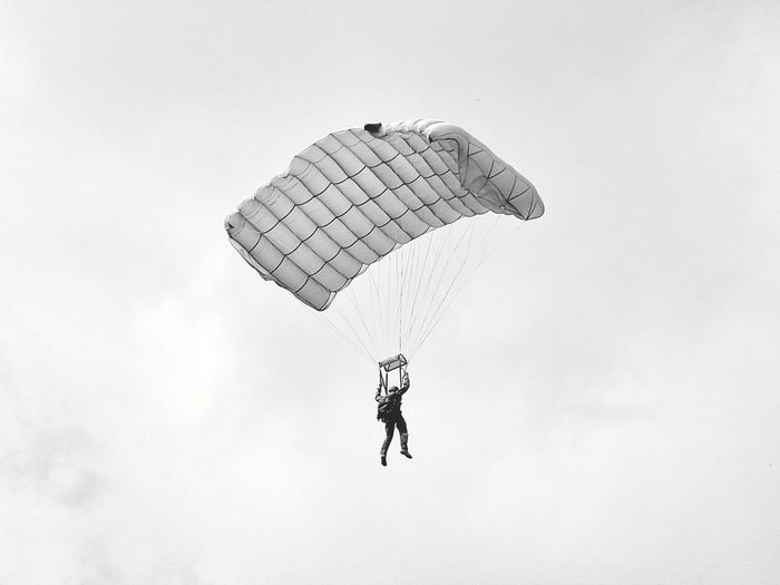 Low angle view of person skydiving against sky