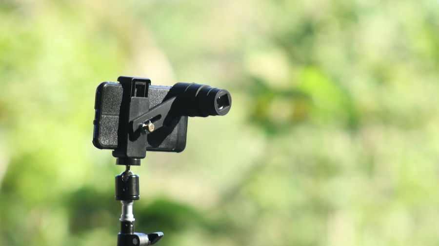 Close-up of camera with toy against blurred background