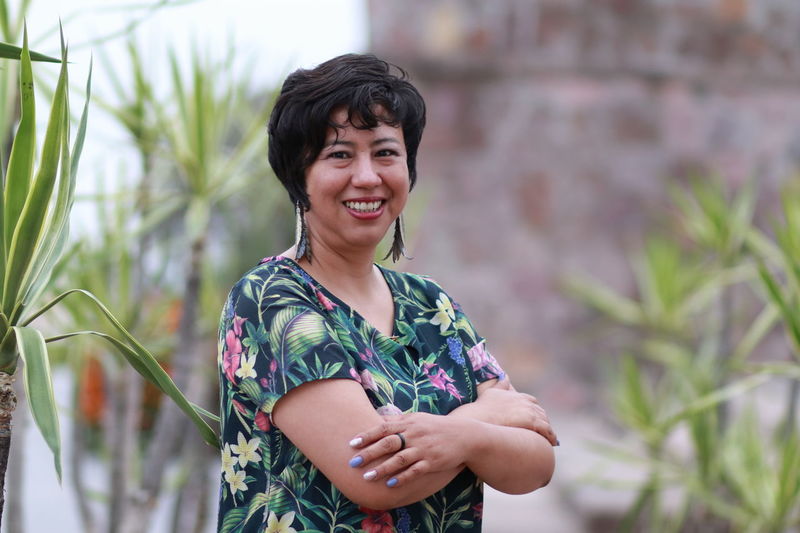 Portrait of a smiling young woman standing outdoors