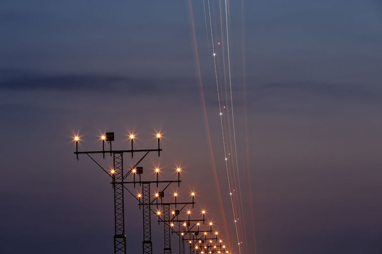 Light trail of airplane during approaching to airport. night scene with landing lights.
