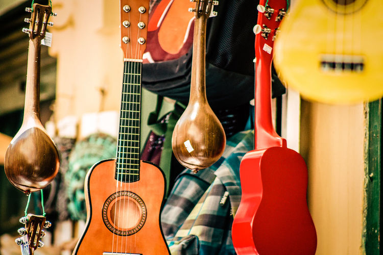Close-up of guitars for sale at market