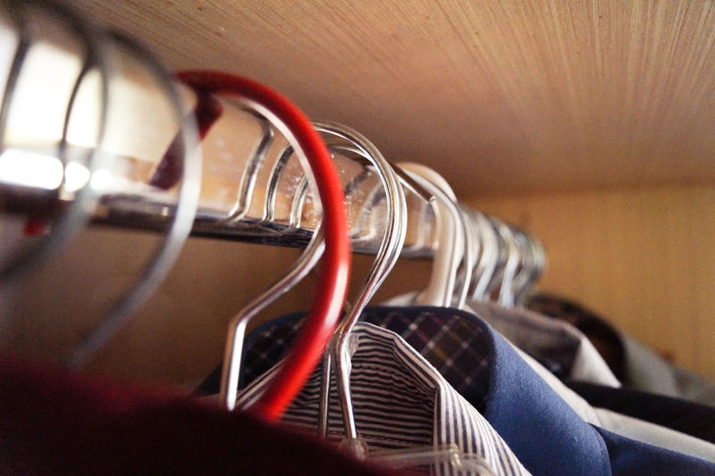 Close-up of shirts hanging on hangers in wardrobe