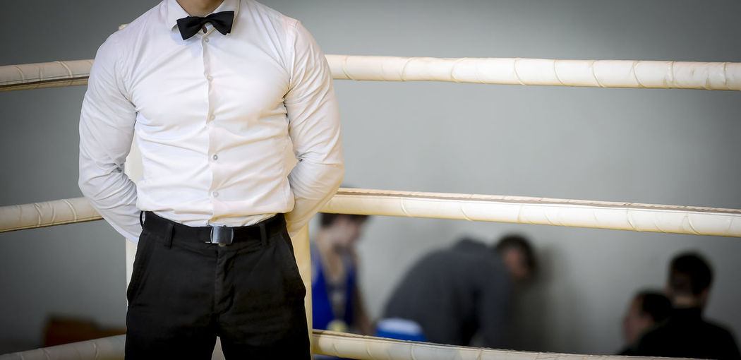 Midsection of referee standing in boxing ring