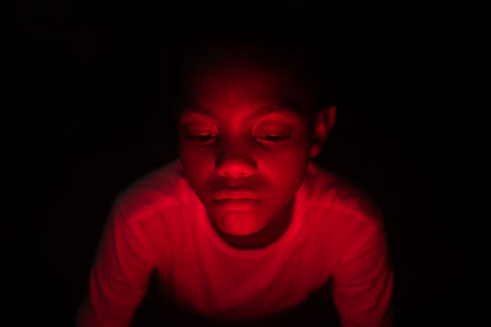 Close-up of boy in darkroom