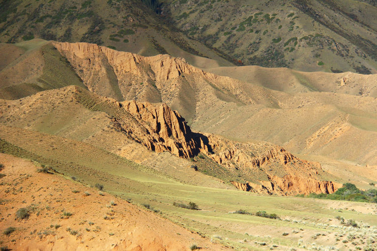 Sandy-clay relief slopes of the mountain range on the assy plateau in autumn in sunlight