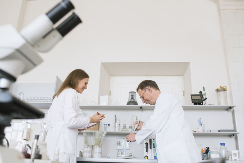 Researchers in white coats working in lab