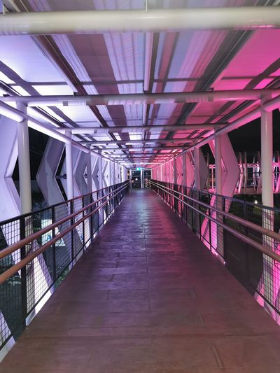View of beautiful empty footbridge with color lighting effect in urban city. 