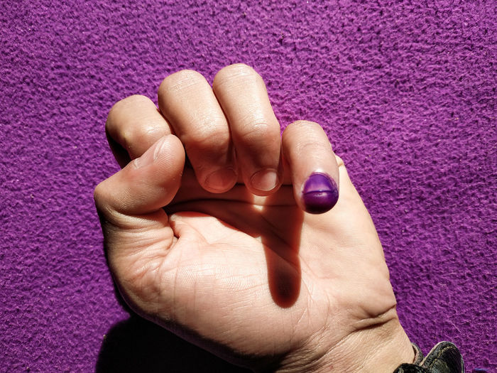 Close-up of woman hand on purple