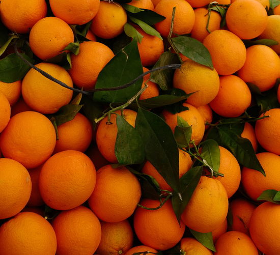 Orange organic tangerines with green leaves