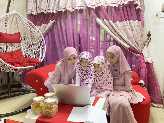 A family looking at laptop for online video conferencing