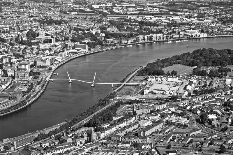 Aerial view of peace bridge over river foyle amidst city