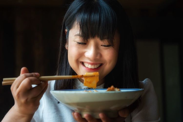 Smiling woman having food