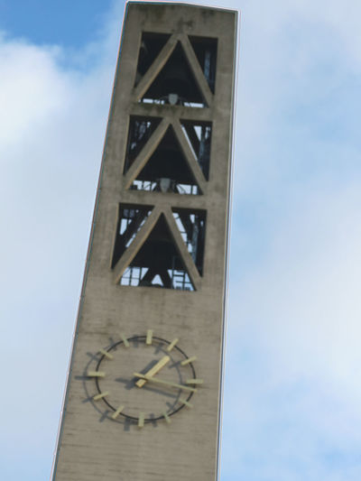 Low angle view of clock against sky