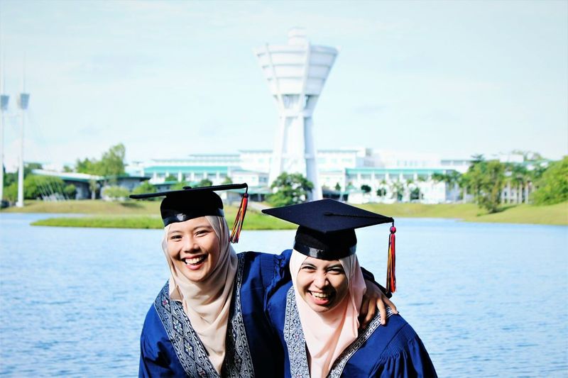 Portrait of a smiling women in graduation robes