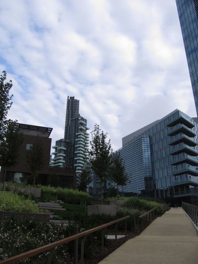 Modern buildings against cloudy sky