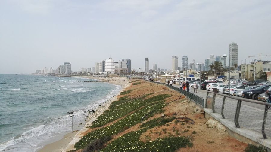 Panoramic view of beach and buildings against sky