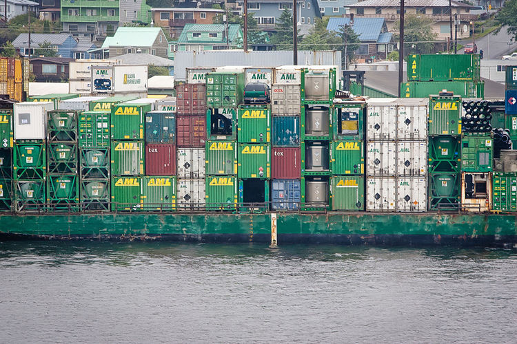 Cargo containers on barge sailing in sea