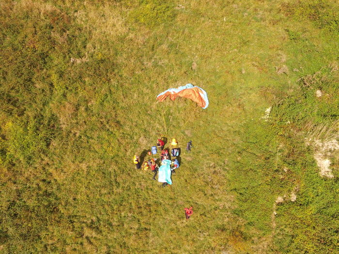 Aerial view of people with parachute on field