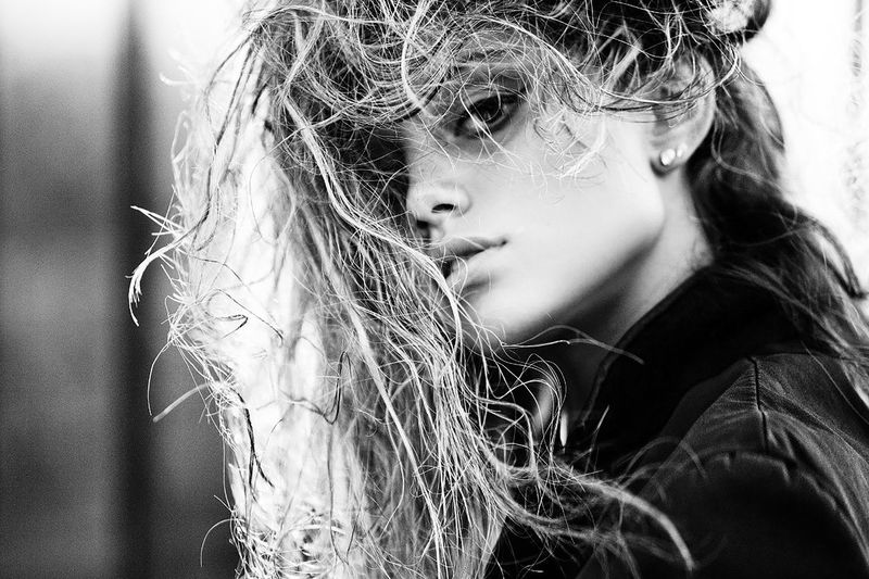 Close-up portrait of young woman with messy hair