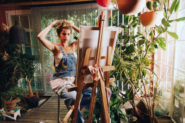Young woman looking on easel