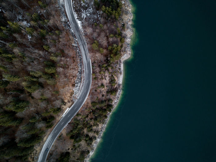 Aerial view of road by river against sky