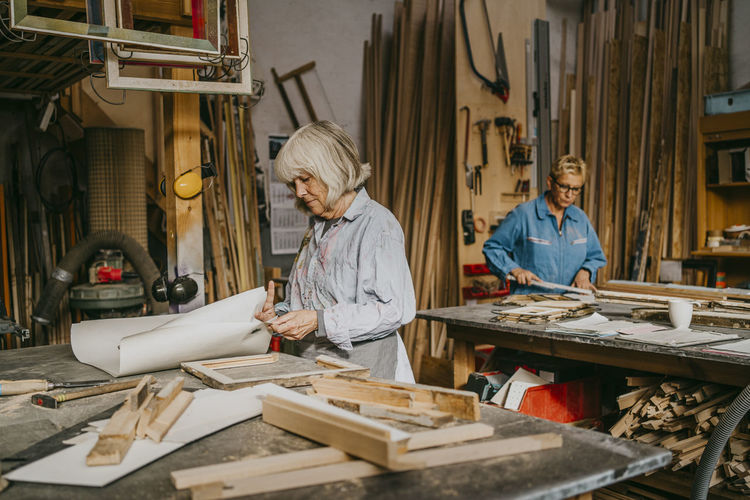 Senior craftswomen working together at repair shop
