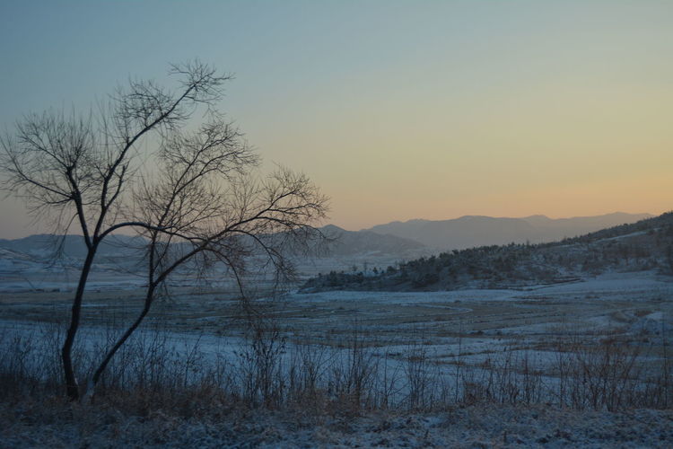Scenic view of lake against sky during sunset