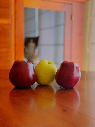 Close-up of apples on table at home