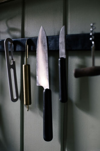 Kitchen knife and tools hanging on magnet