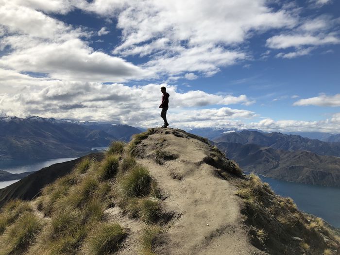 Man standing on mountain against sky roys peak