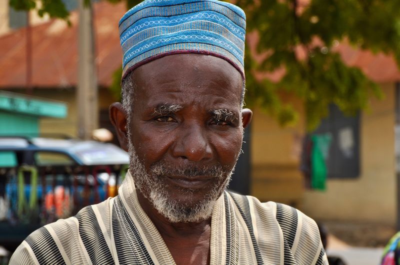 Close-up portrait of man in skull cap outdoors