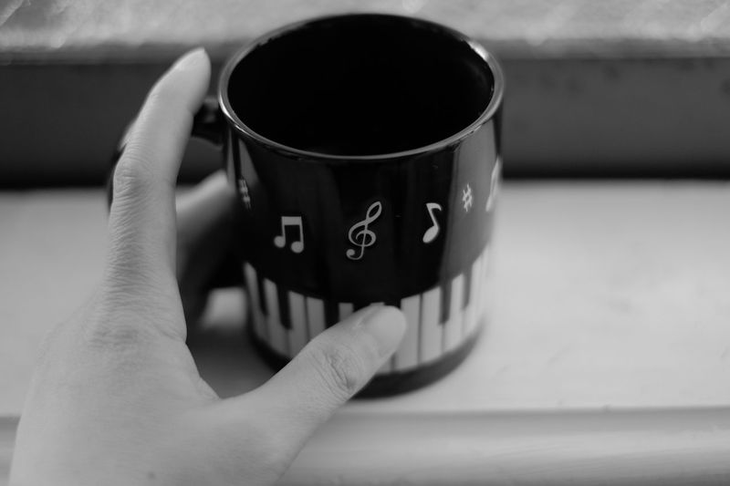 Close-up of hand holding coffee cup