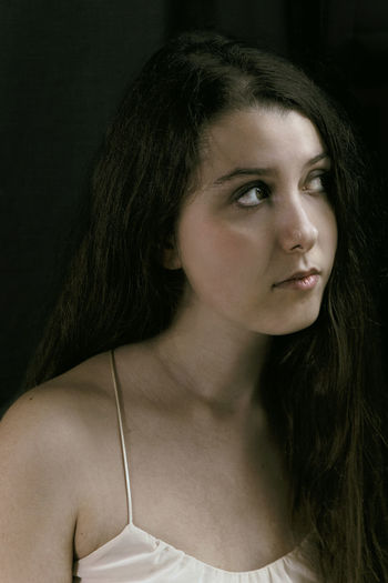 Close-up of beautiful young woman looking away