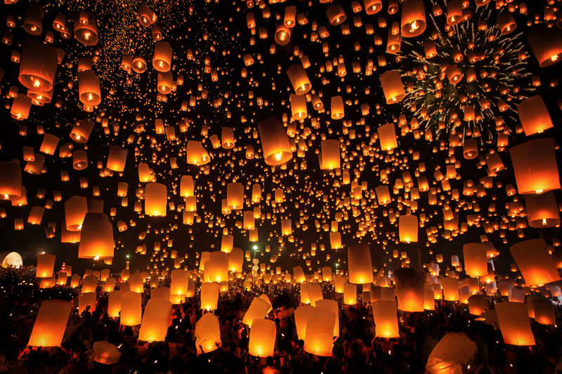 Illuminated lanterns over crowd in city at night during yi peng