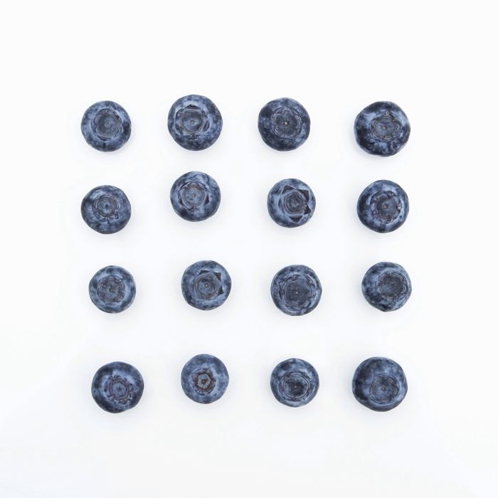 Close-up of blueberries on white background