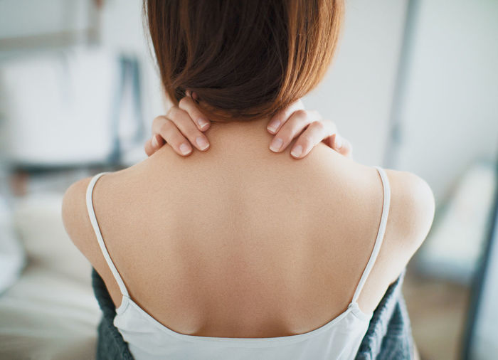 Rear view of young woman at home