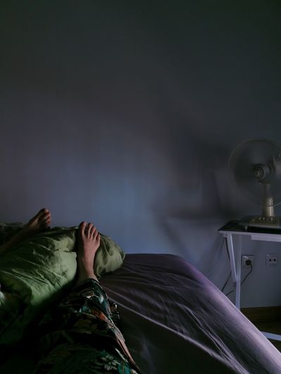 Woman sleeping on bed at home
