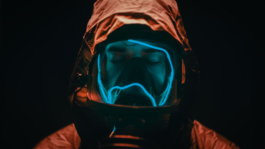 Man with suit and gas mask at night