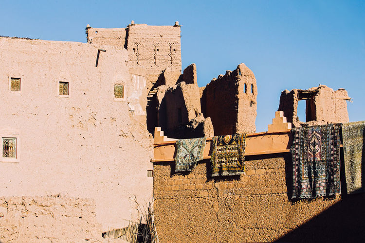 Arabic traditional carpet exposed on berber houses in kasbah of ouarzazate, morocco