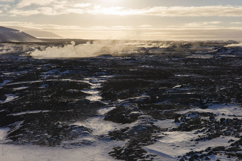 Scenic view of volcanic land against sky during sunset, iceland