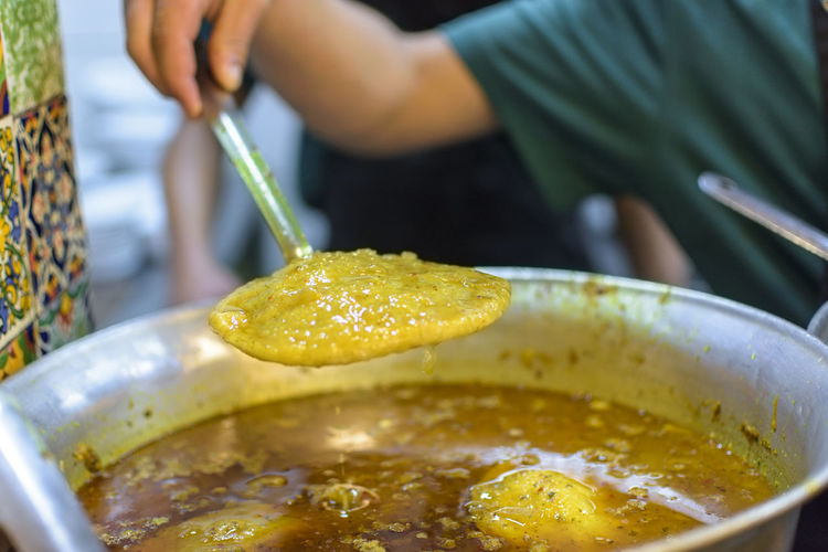 Close-up of hand holding ladle