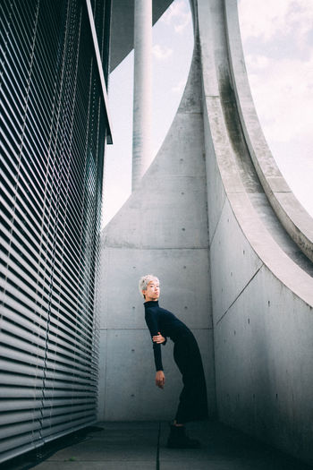 Portrait of woman standing against wall