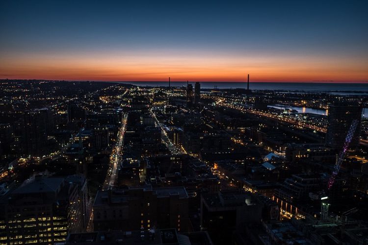 High angle view of city lit up at dusk