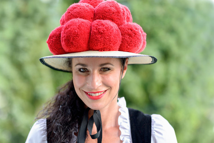 Close-up portrait of confident waitress wearing hat outdoors