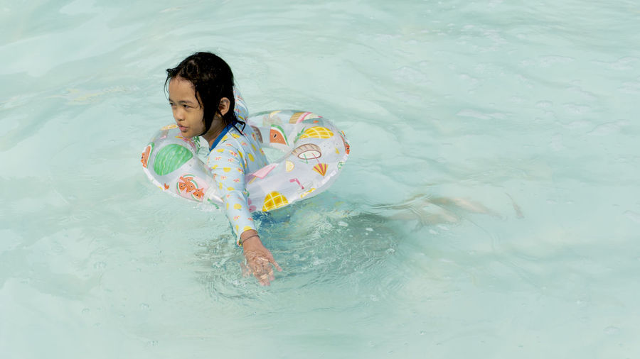 High angle view of girl playing in swimming pool